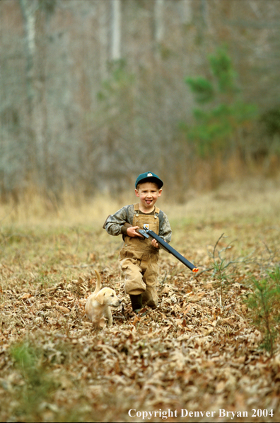 Young hunter with yellow Lab pup.